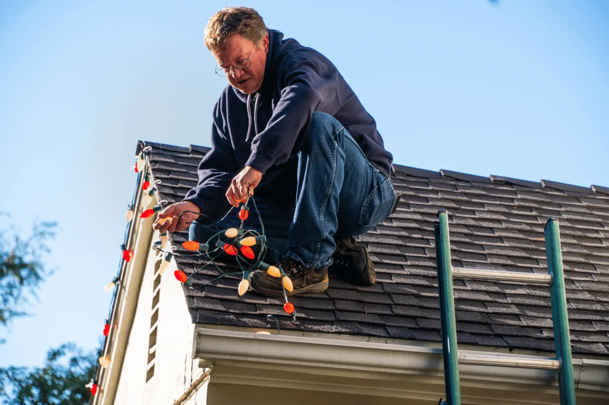 Bright Lights GA crew handling a rooftop Christmas light installation