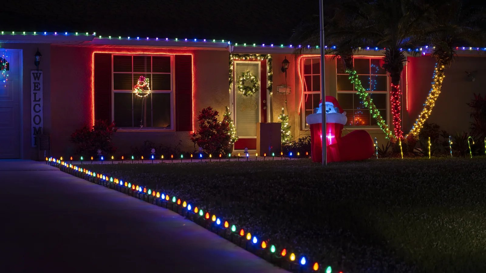 Home with roofline and pathway holiday lighting in Metro Atlanta