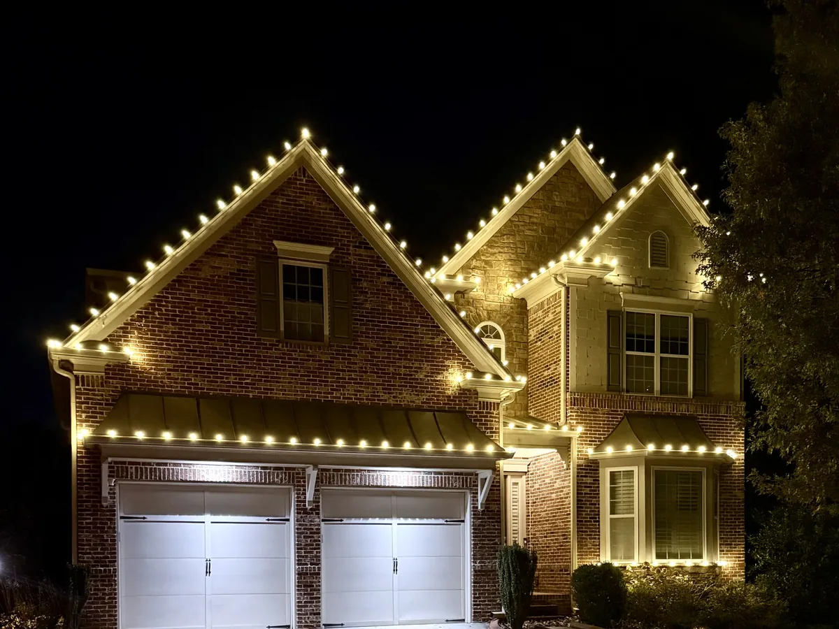 Residential display with roofline, tree and pathway lighting